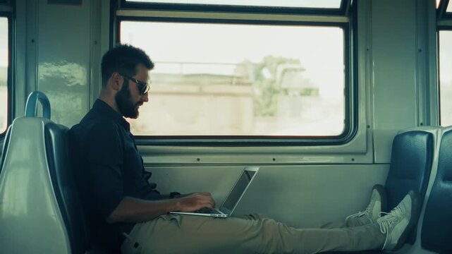 Working on Laptop While Traveling by Train. Remote Work in Public Transport. Online Business Management during Journey