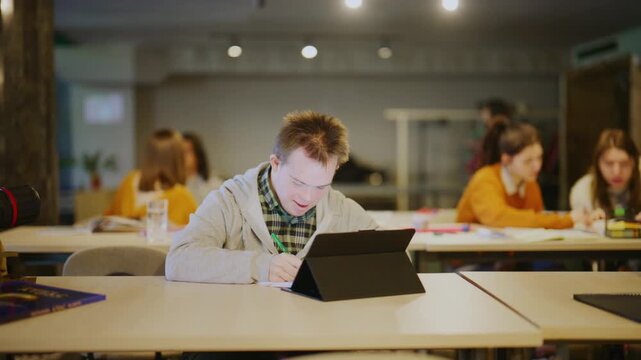 A cheerful young man with Down syndrome expresses joy after a successful learning moment in a classroom. This happy student celebrates his achievement while studying with peers.