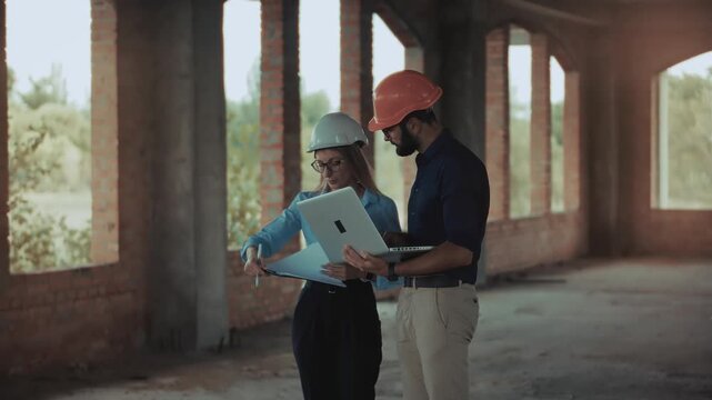 Architect and Engineer Discussing Blueprints on Construction Site.  Team Civil Engineering Project Management. Real Estate Architecture Coordination