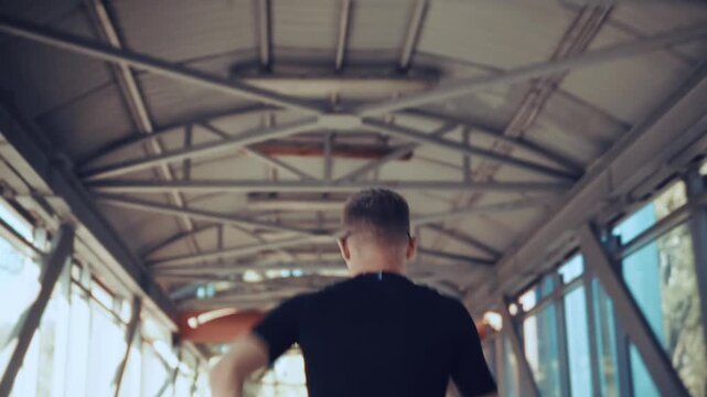Runner Training On Glass Bridge In City. Athlete Jogging On Urban Overpass. High Speed Motion And Endurance Practice