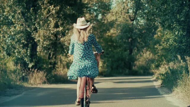 Riding Bicycle Along Road In Summer Park. Active Leisure Outdoor Recreation During Vacation. Nature Exploration