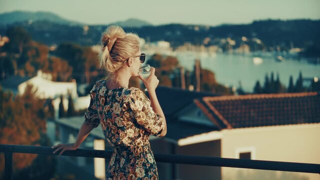 Traveler  Enjoying Scenic Sunset View In Resort Town. Relaxation On Terrace With Sea