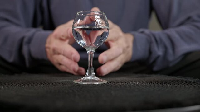 Alcohol addiction. Nervous man sits with glasses of alcohol, symbolizing problems and alcohol addiction