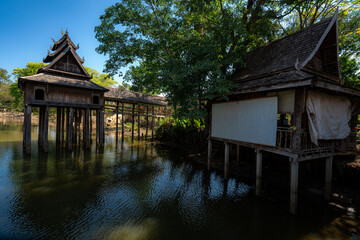 Naklejka premium Hotay Pidok Buddhist library stilts pond reflection Lamchan Laos