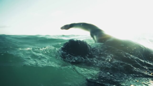 Swimmer Training In Open Water In Ocean Waves. Preparing Athlete For Triathlon Competition