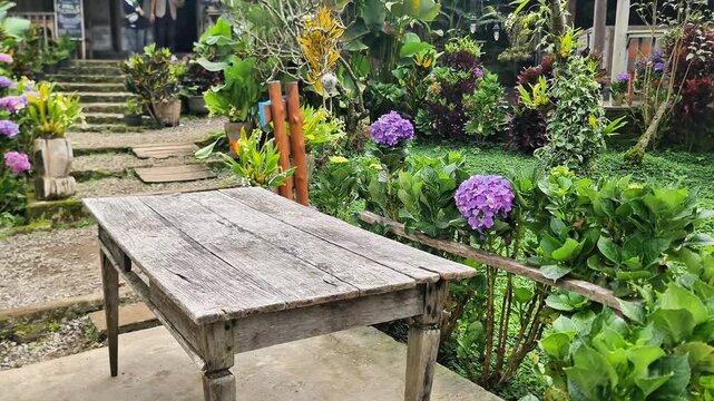 Authentic Javanese Heritage Site: A Rustic Table Amidst a Flowering Garden
