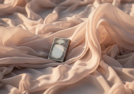 Vintage cigarette case resting on draped silk fabric with soft lighting