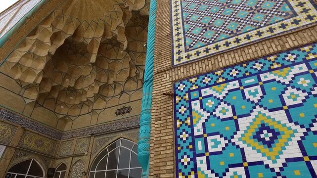  Close up of intricate blue tilework on a mosque wall, displaying geometric patterns and traditional Islamic decorative art with cultural and religious significance. 