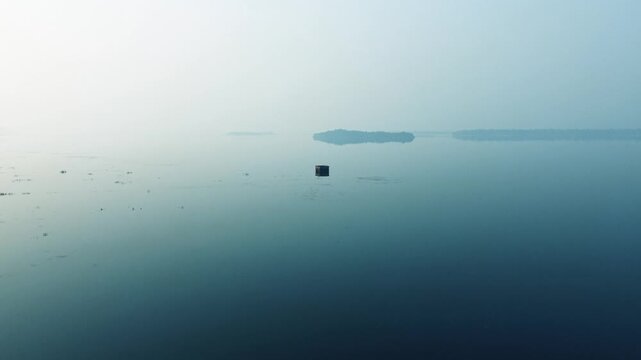 A view of a dilapidated house amidst the waters of the Mukutmanipur Dam, Drone Shot