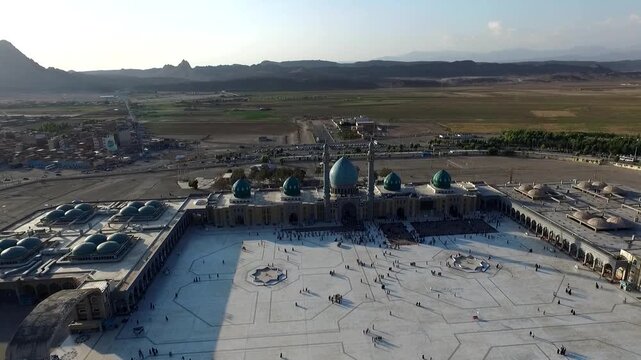  Drone perspective over a mosque complex and surrounding plains showcases domes, courtyard geometry, and the relationship between sacred architecture and the wider landscape. 