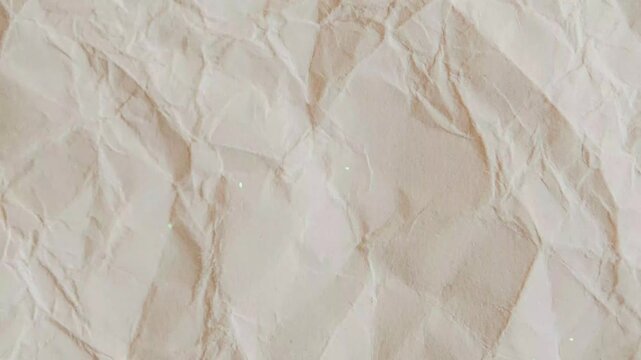 Closeup of crumpled beige paper texture background animated background