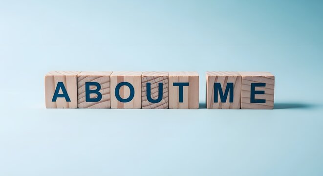 Wooden blocks spell out 'about me' on a light blue background