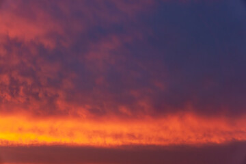 Fototapeta premium Fiery sunset sky with dramatic cloud layers