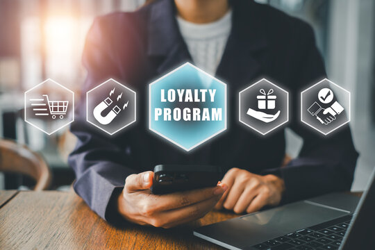 Professional woman using smartphone for loyalty program in office, surrounded by digital marketing icons.