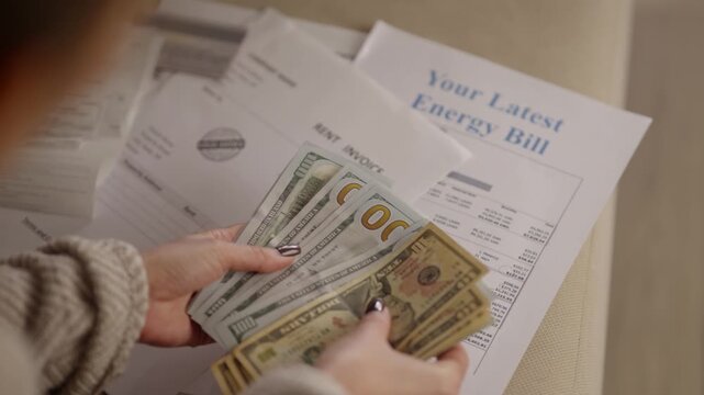 Counting US Dollar Banknotes. Calculating Monthly Expenses and Household Utility Payments. Paying Bills With Cash