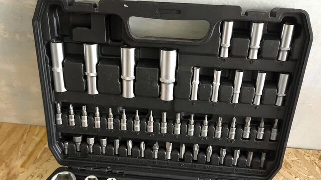 A large open case with ratchets, screwdriver attachments, hand tools. Car repair shop, garage
