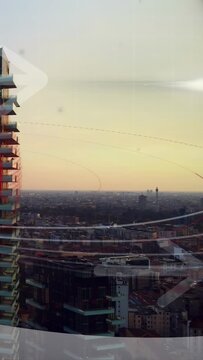 Vertical video: Camera panning right tower sliding left, faint arrow crossing glass showing horizon