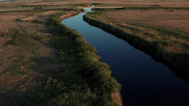 Aerial view of Ubagan river winding through steppe landscape in Kostanay region Kazakhstan, natural scenery with calm water, open plains and rural environment, untouched nature from above