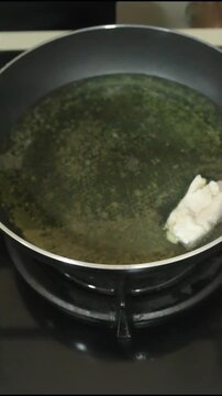 Chef Hand Frying Fresh White Tofu in Hot Oil Pan