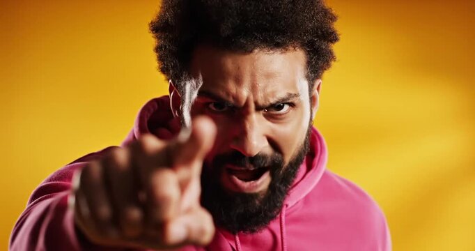 Man Pointing at Camera with Angry Expression.