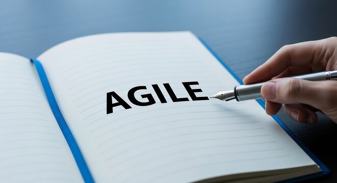 Agile methodology concept written in notebook with pen on dark desk