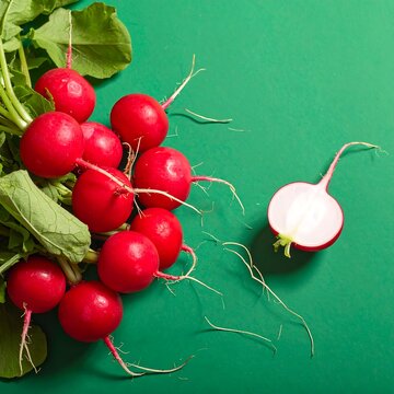 Fresh radishes on green background