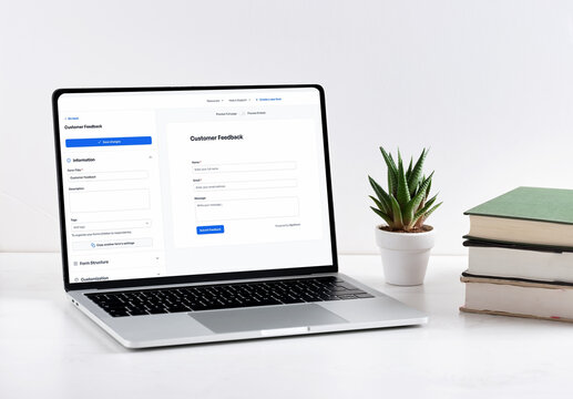 Customer feedback form on laptop screen with books and plant