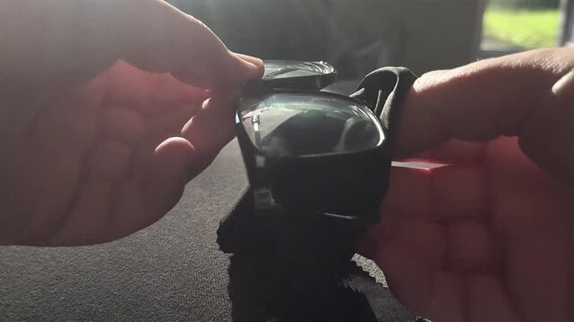 Cleaning eyeglasses with cloth in warm sunlight close up care routine