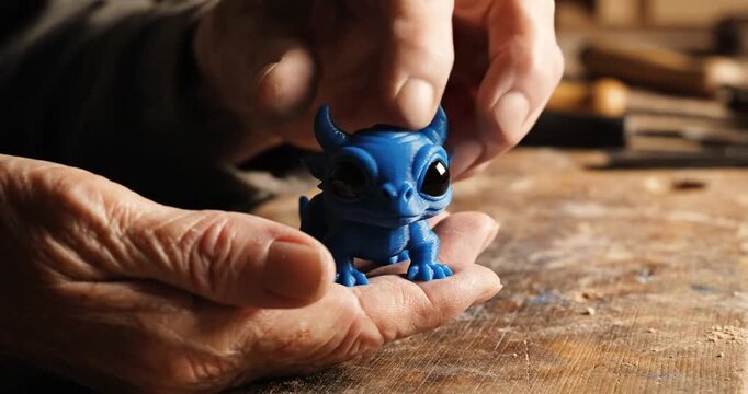 Hands Holding Small Blue Figurine Closeup.