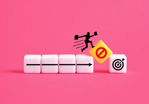 Businessman jumping over obstacle to reach target avoiding prohibition sign