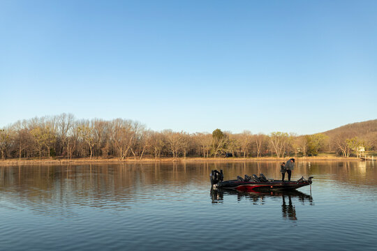 Father and son standing together on a boat deck during a fishing trip