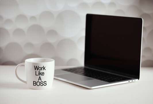 Work like a boss: laptop and coffee mug inspiring to work harder