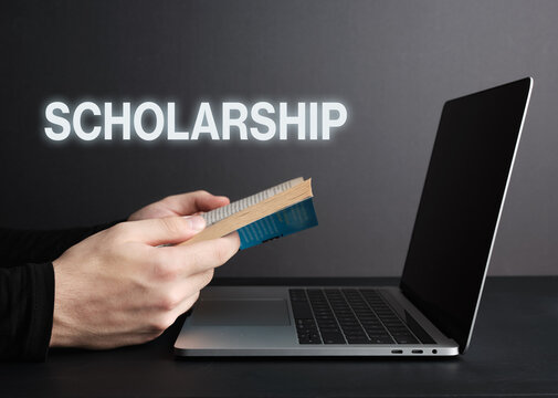 Student Reading Book and Studying Scholarship Program on Laptop