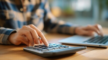Fototapeta premium Woman using calculator and laptop