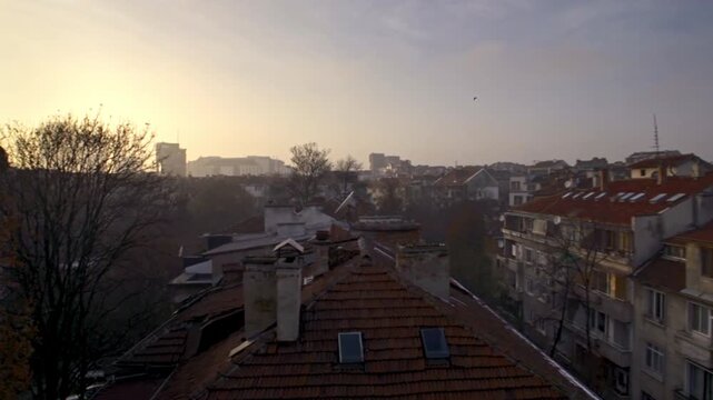 4K video of an urban landscape, beautiful sky and fog at sunset, of the Soviet and communist houses and buildings in the city center of Sofia, Bulgaria, the Balkans in Eastern Europe, European Union.