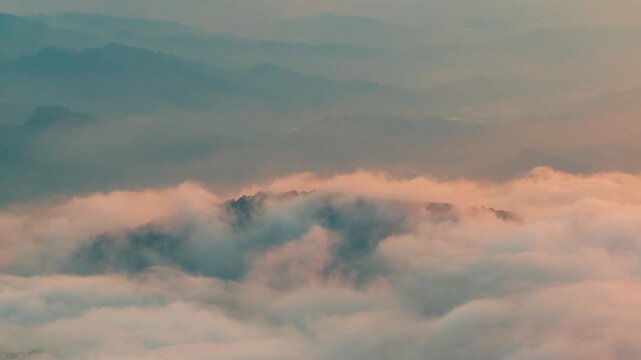 Aerial view above the sea of ​​clouds with the sunset