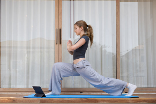 Caucasian woman engaged in a yoga session in a living room