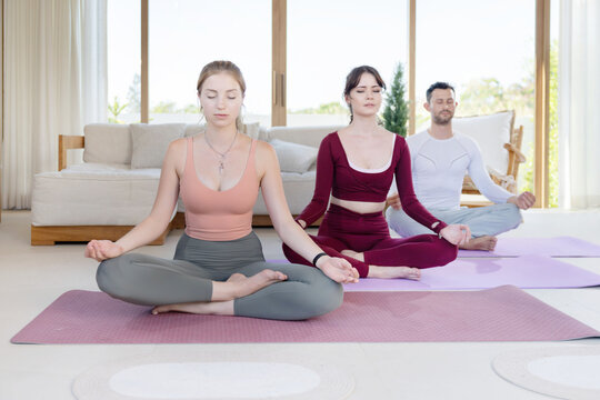 Group of people practicing meditation and yoga postures