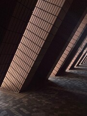 Naklejka premium Abstract architectural corridor with repeating columns and geometric pattern