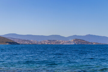 Fototapeta premium Beautiful coastal landscape with turquoise sea, rocky shore and green hills. Travel, vacation, summer holiday and tourism concept.