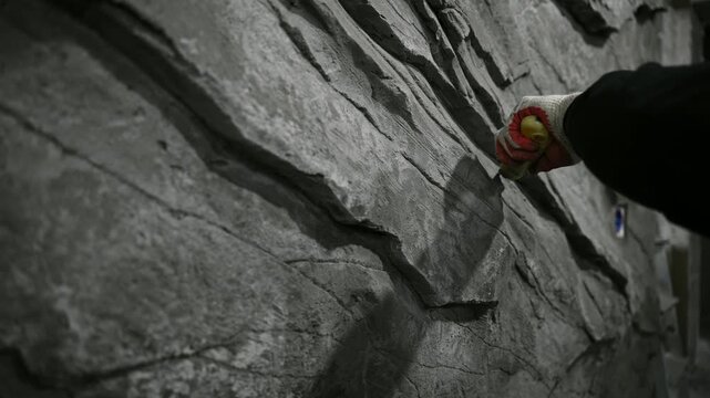 Detailed View Of Sculptor Skillfully Creating Textured Decorative Wall Artwork With Tools And Patience