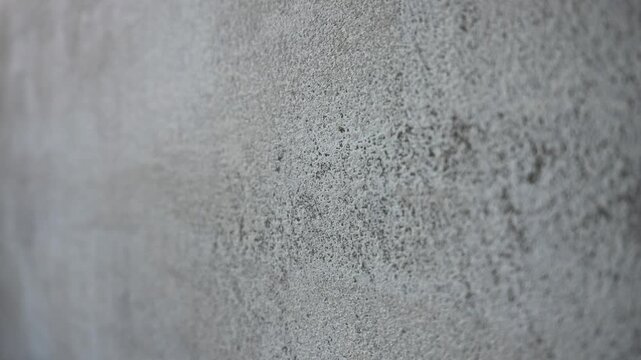 Intimate Photograph Highlighting Rough Concrete Wall With Subtle Markings And Atmospheric Lighting