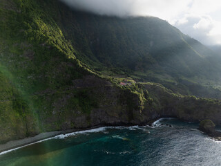 Coastal cliffs and rocky formations extending into the Atlantic Ocean on Madeira Island. Natural island coastline © Leonid