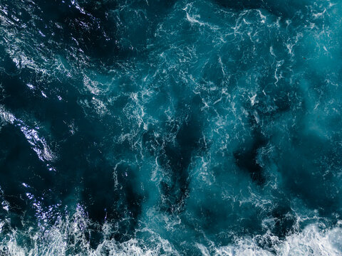 Open ocean surface with energetic waves and sea foam, constantly changing water patterns