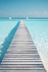 Fototapeta premium A long wooden pier goes out over the clear blue water in resort. Visitors can walk along the pier to enjoy views of the ocean and boats. This spot attracts many tourists each year