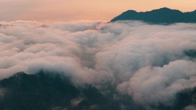 Aerial view above the sea of ​​clouds with the sunset
