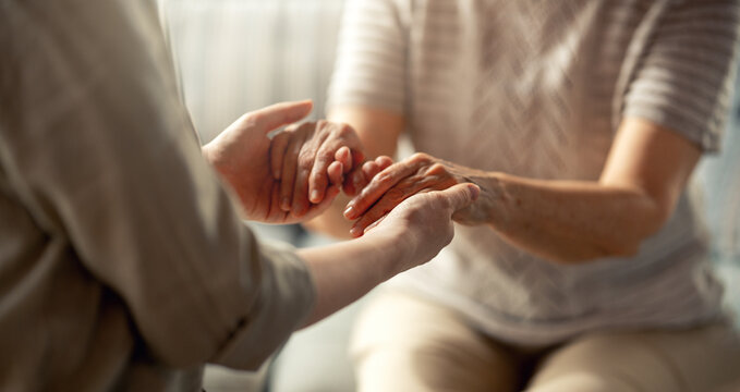 Compassionate Caregiver Holding Elderly Woman?s Hands, Comfort and Support Concept