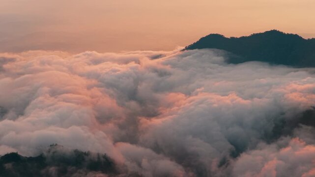 Aerial view above the sea of ​​clouds with the sunset