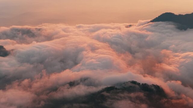 Aerial view above the sea of ​​clouds with the sunset