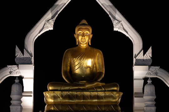 Lopburi, Thailand, April 12, 2025, Puttha Sathan Lopburi Sri Suvarnabhumi - Golden Buddha statue illuminated at night in Lopburi